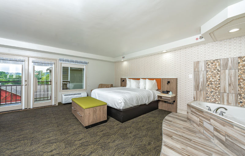 A view of room with one king bed and whirlpool